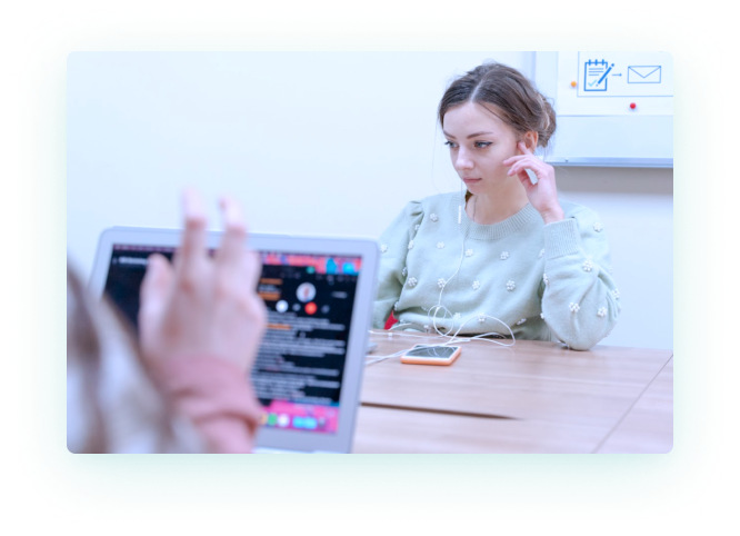 Girl with Headphones and a Hand Before Laptop Screen